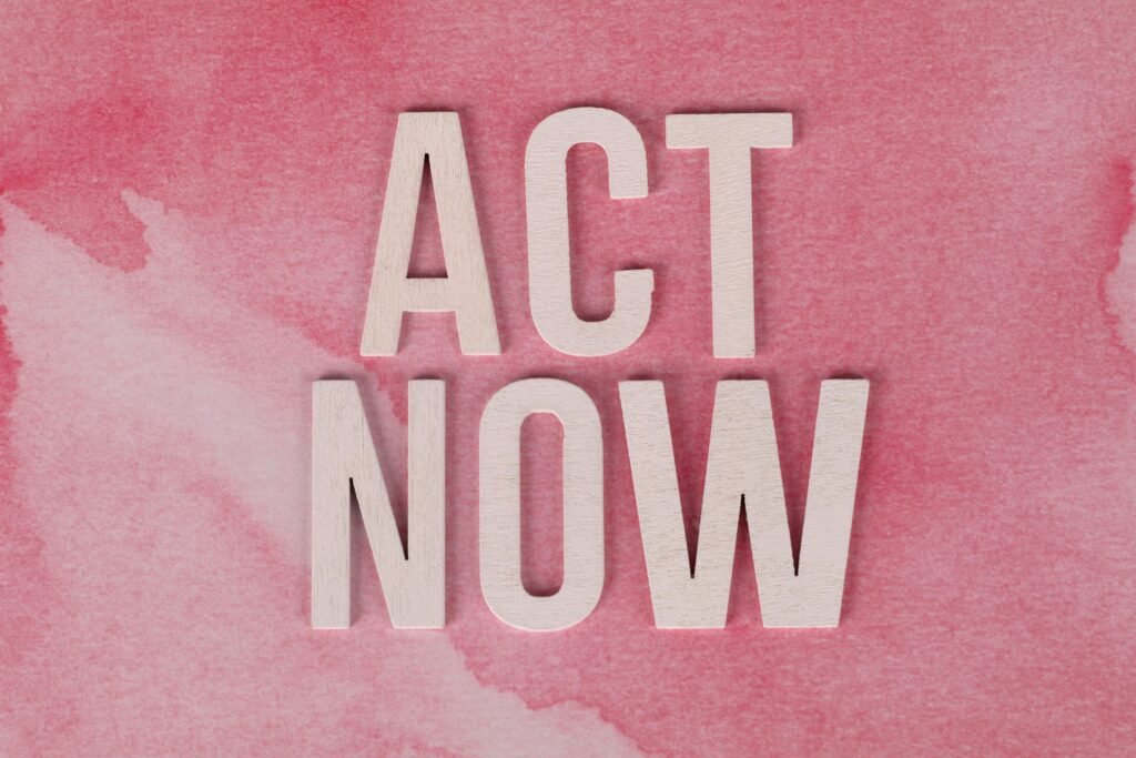 Inspiring 'ACT NOW' message on a pink watercolor background to motivate action.